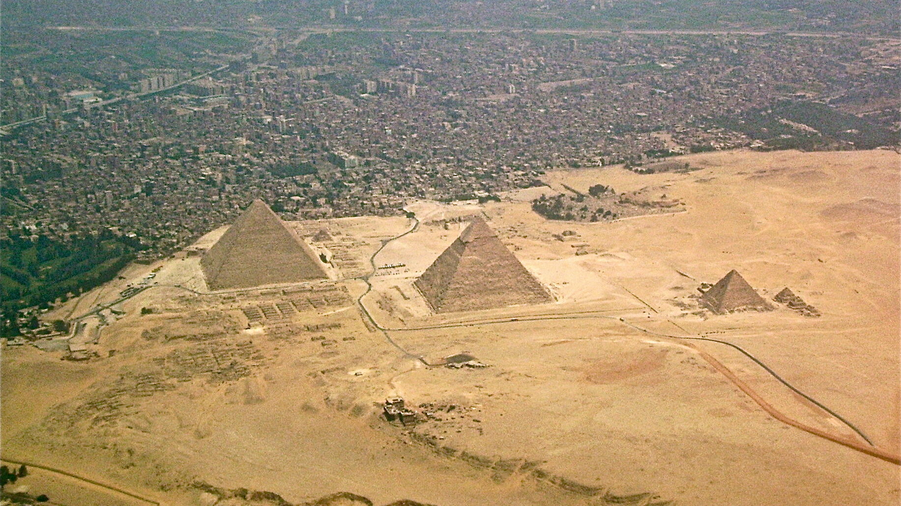 Aerial photo of the Pyramids of Giza with the city in the background